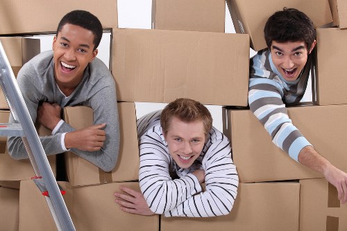 Packed boxes and furniture ready for removal services in a Frognal property