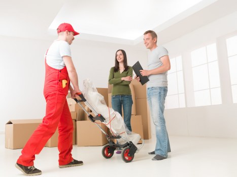 Careful unloading of household items at a Frognal flat or house