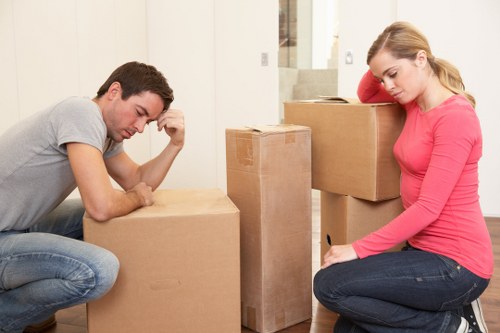 Driver and helper delivering furniture at a property entrance