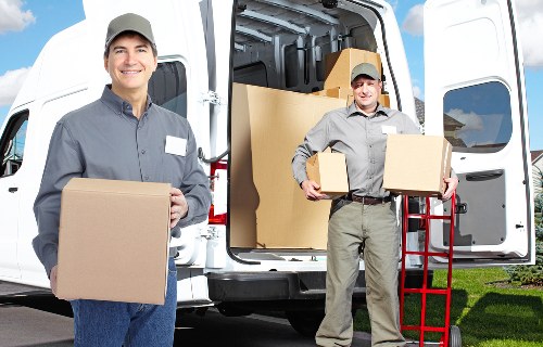 Professional movers handling furniture in a Frognal flat move